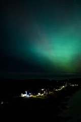 The Aurora Borealis, the northern lights, showing up above Portnoo in County Donegal, Ireland © Lukassek
