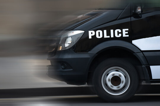A fast police car speeding on the road, showcasing law enforcement response, high performance, and emergency mobility in urban or highway settings.