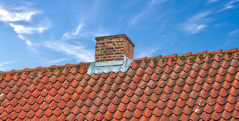 Naklejka premium Tiles, chimney or roof of house, building or outdoor with residential structure by sky. Architecture, home or ventilation for air pollution with brick on rooftop, weathered metal and moss with space