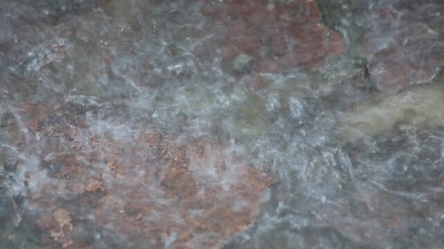 Close-up of Heavy Rain Splashing on Pavement During a Spring Storm