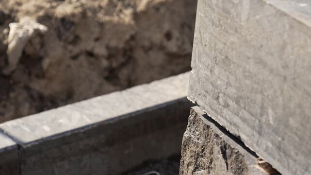 A granite curb was installed on the edge of a city road during renovation, road repairs, and the installation of curbs and sidewalks.