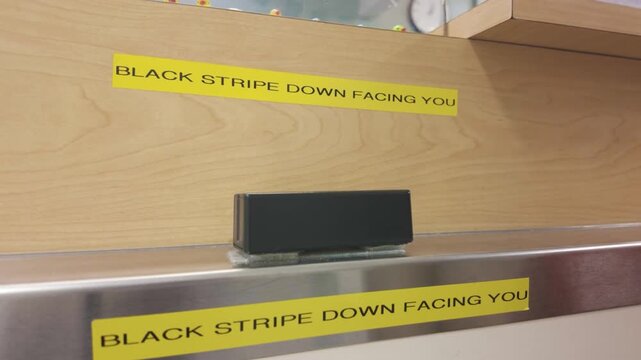 Card reader at retail counter with black stripe down facing you sign