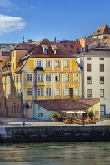 Fototapeta premium Historical Wurstkuchl sausage kitchen in Regensburg, Germany. Old town architecture on Danube river bank under blue sky