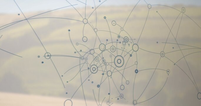 Displaying etched network decal covering glass pane from rural hill view, showing blurred fields