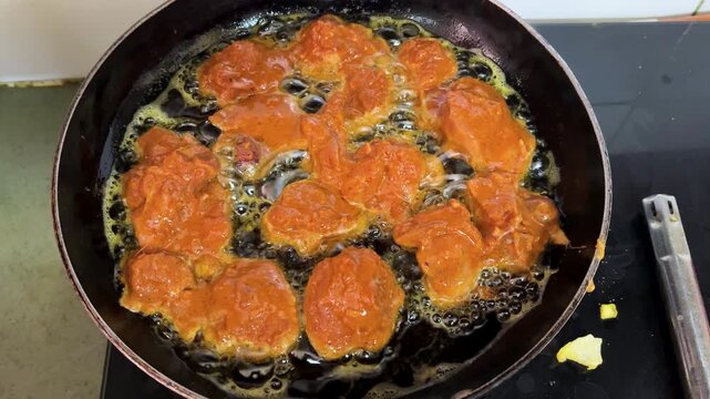spicy chicken fry in oil with bubbling texture and rich marinade coating