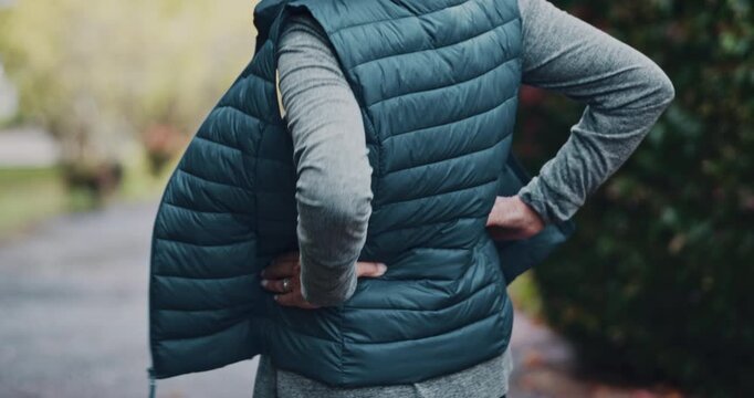 Senior, woman and back pain with fitness injury for workout accident or overworked strain in nature. Elderly, female person or runner with sore spine or joint inflammation for fibromyalgia or tension