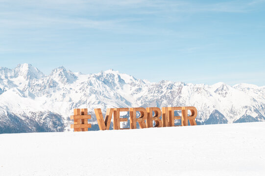 Verbier hashtag sign with snowy mountains