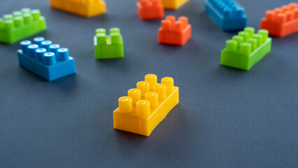 Close Up of Yellow Plastic Building Block with Blurred Background