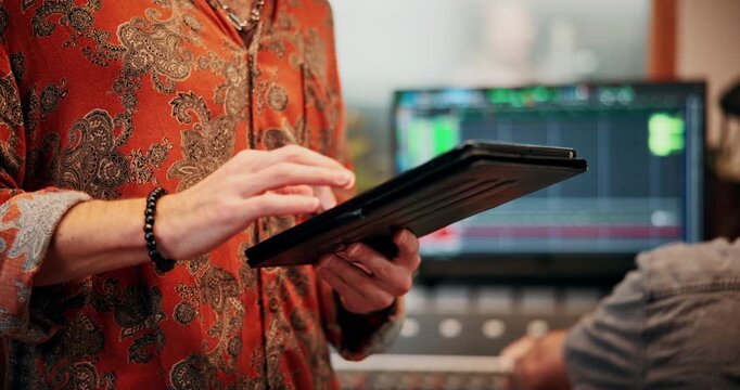 Man, hands and team in music studio with tablet, research trends and website for song inspiration. Coworking, person and typing with tech for creativity, record label or download app for album ideas.