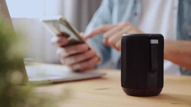 Right Frame Smart Speaker Virtual Assistant or Artificial Intelligence Concept by Man Connecting Smart Phone with Smart Speaker