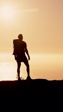 Ocean, hiking and man with view, silhouette and hobby in nature, sunset and fitness. Outdoor, hiker and person with water, summer holiday and trekking for healthy benefits, exercise and reflection