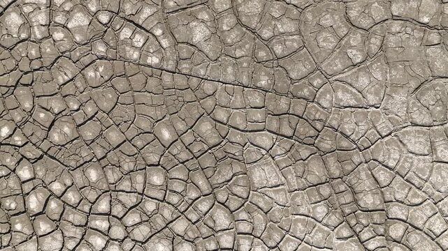 Aerial view of intricate cracked earth patterns and dry mud texture in Minas de Riotinto, Andalusia, Spain.