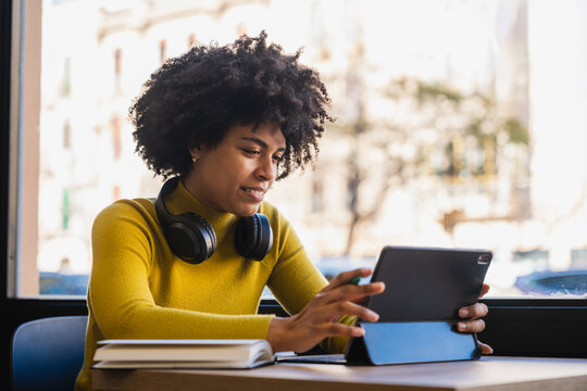 Young woman concentrating on digital tablet content