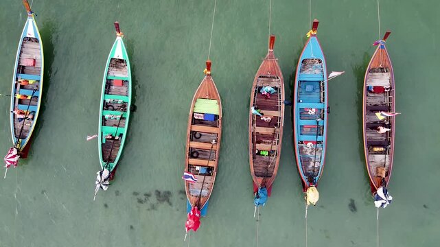 Aerial view of famous Patong Beach in Phuket with boats at sunset, Thailand. Slow motion