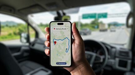 Fleet driver using smartphone navigation for delivery route tracking inside vehicle, supporting logistics monitoring, route optimization and operational planning for fleet management and business perf © onephoto