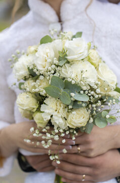 Couple's hands wearing engagement and wedding rings, symbolizing love, commitment, and marriage. A close-up view of joining hands