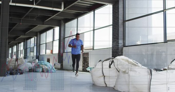 Man sprinting from far corridor in industrial fitness drill, jumping over large fabric sack