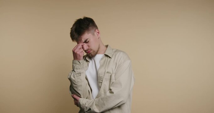 Young man shows expressions of thought and worry in simple studio setting