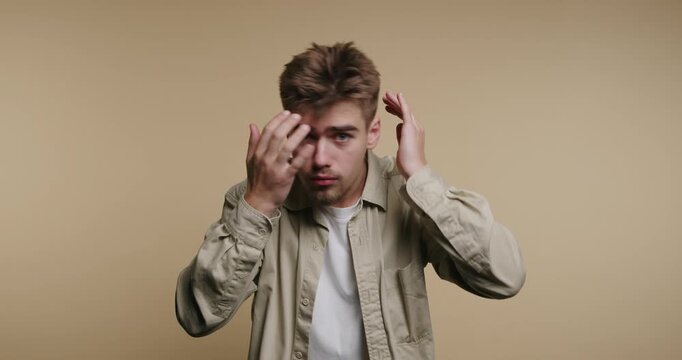 Young man styles hair in front of a plain background while adjusting his appearance in four different frames