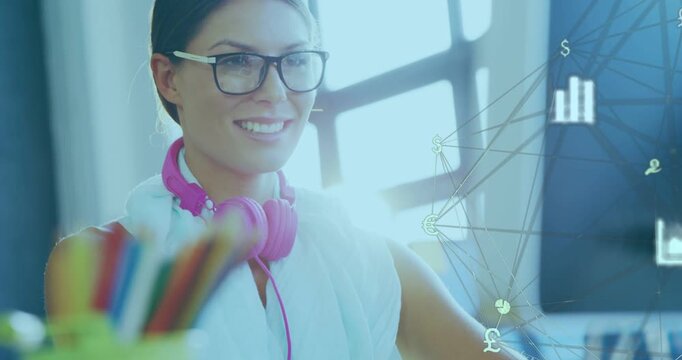 Woman typing at desk, causing animated finance overlay from screen showing $&pound;&euro; charts for analysis