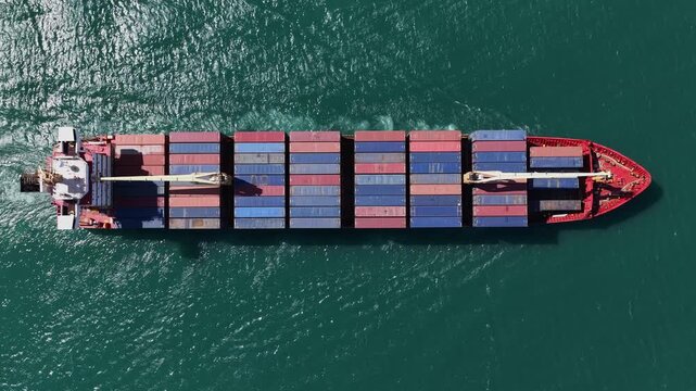 Lisbon, Portugal - 30 March 2026: Aerial view of a large container ship sailing on the vast, dark turquoise sea, creating a striking contrast.