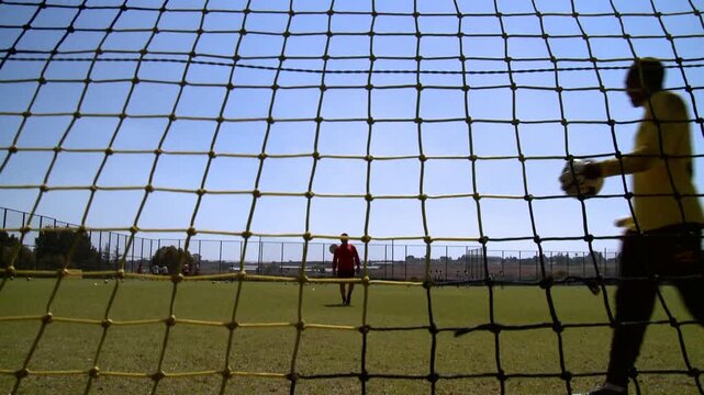 soccer goal keeper from behind the net