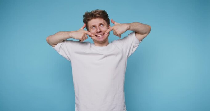 Man shows different expressions against a blue background in a playful activity at home