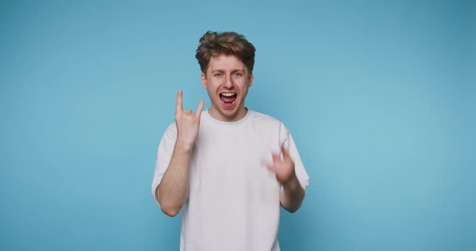 Person shows various hand signs in front of blue background while expressing different emotions and attitudes