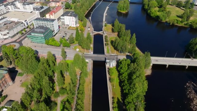 Panoramic drone shot around the canal on Pielisjoki river, summer day in Joensuu
