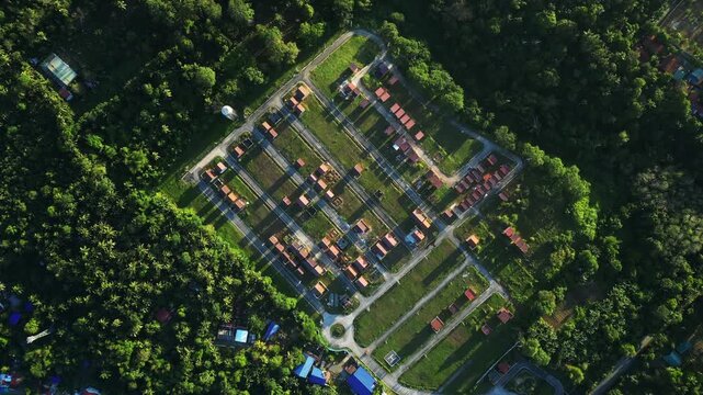 Smooth rotating aerial shot circling a peaceful residential neighborhood surrounded by lush greenery and natural scenery at Camella Homes Alfonso Cavite Philippines