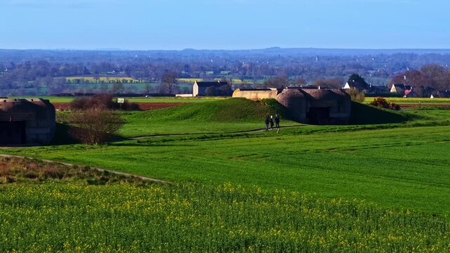 Historic Longues-sur-Mer battery German bunkers in green spring fields