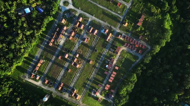 Top view drone shot highlighting the structured layout of a tropical residential community with aligned homes and green surroundings at Residential Subdivision in Cavite Philippines