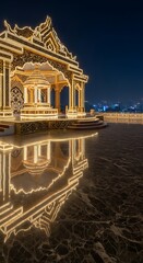 Fototapeta premium Ornate golden pavilion illuminated with warm lights at night reflecting on wet marble floor with city skyline in background