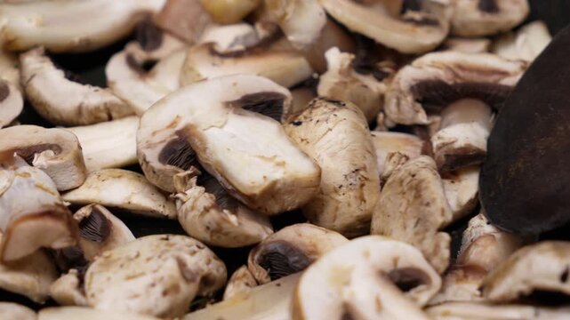 Freshly sliced champignon mushrooms, indoors, March season cooking