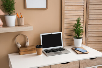 Fototapeta premium Interior of office with workplace, wooden folding screen and cypress trees