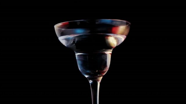 Video of glass of martini on black background
