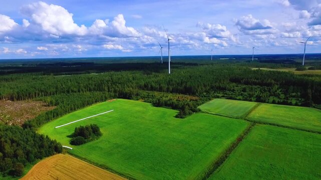 Aerial View of Lush Green Fields and Wind Turbines Under a Blue Sky with Fluffy Clouds in Finland