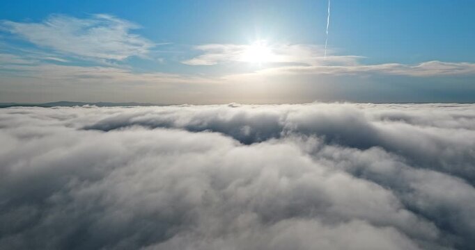 Breathtaking aerial footage flying above clouds bright sun shining summer sky. Morning sunrise heaven perspective drone view. Tranquility peace freedom nature landscape inspiration concept.