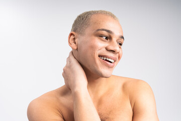 Naklejka premium Handsome stylish man exudes charm and confidence with a playful smile in soft light