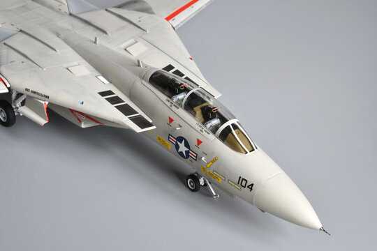 Florence, Italy - April 1th 2026: Scale model of a fighter plane F-14A Tomcat on a grey background. Toy.