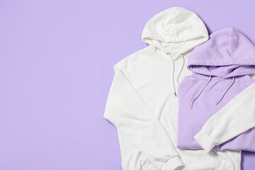 Naklejka premium Stylish hoodies on lilac background