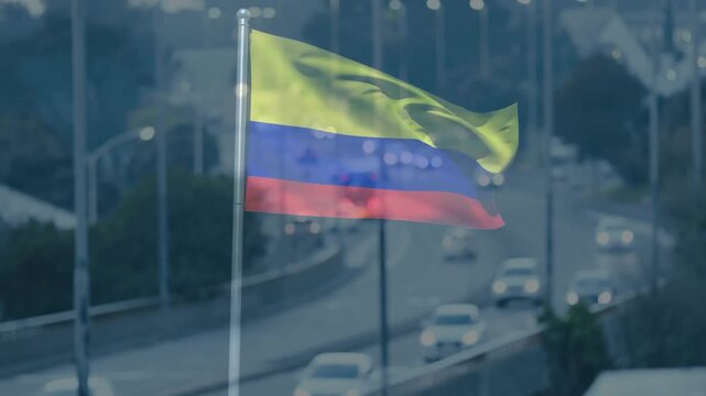 Tricolor flag waving above flowing traffic in flat design, showing silver flagpole, bokeh lights