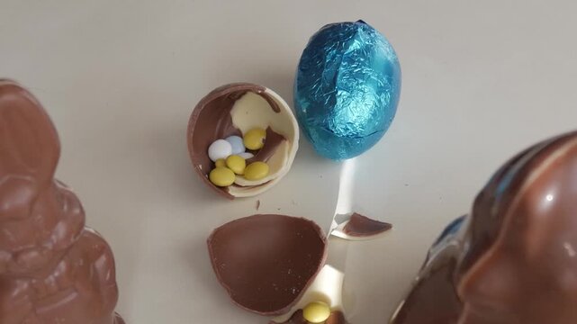 Easter eggs with colorful candy on table, joyful chocolate surprise