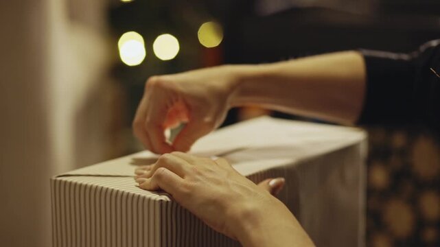 Gift Wrapping - Sealing Gift Wrapper With Adhesive Tape. - closeup shot