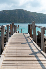 Naklejka premium Scenic wooden pier overlooking tranquil sea coastal landscape photography daytime serene vibes
