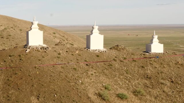  Sacred Buddhist stupa structures among the red sandy hills of the Gobi Desert, Mongolia.