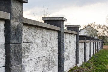 Gray concrete block wall fence in a residential area