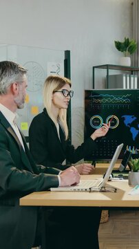 Close up of good-looking high-skilled international male and female team of ecologists which gethering together in conference room to analize earth problems