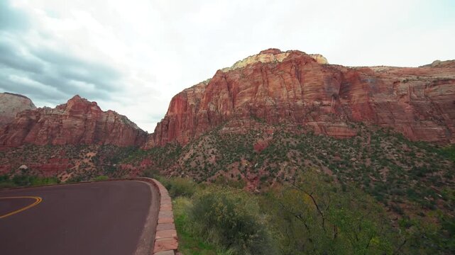 Footage capturing the breathtaking scenery along the Zion-Mount Carmel Highway (Route 9) in Zion National Park, Utah. Towering red sandstone cliffs and majestic mountain formations line the scenic dri