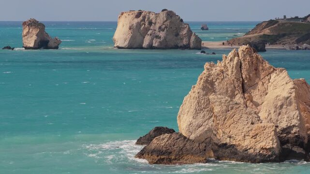 Aerial drone view of Aphrodite's Rock surrounded by turquoise waters and rocky coastline in Cyprus
